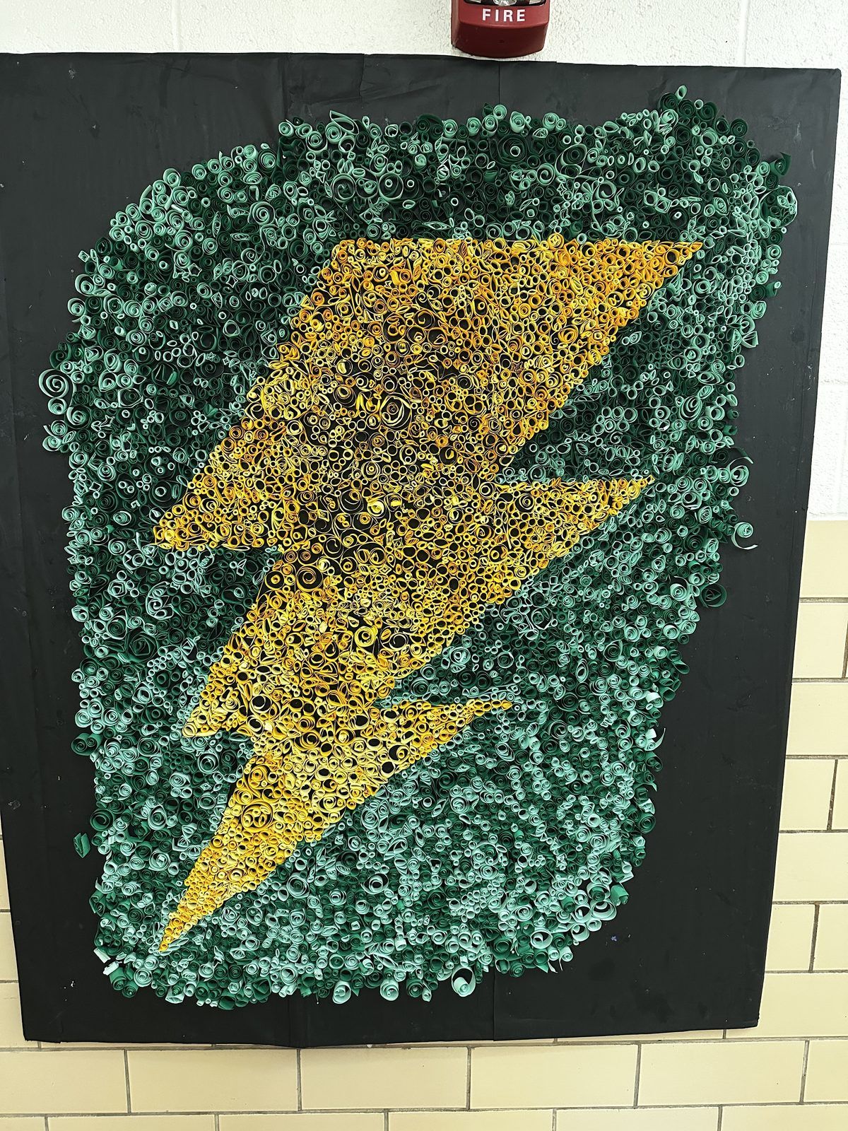 Mosaic of the Northmont Thunderbolts gold lightning bolt on a green field