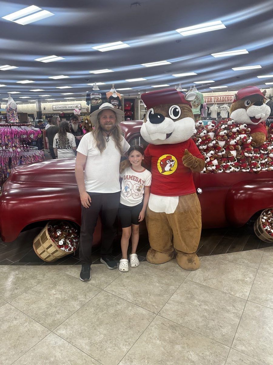 Steve and his daughter posing with the Buc-ee’s beaver mascot inside the Huber Heights store