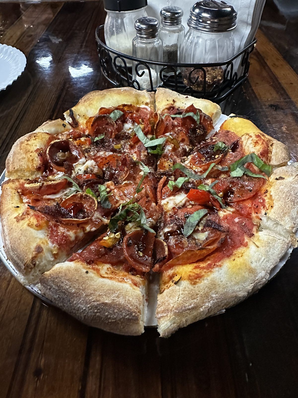 Pepperoni and basil pizza on a wooden table at Hairless Hare Brewery in Vandalia